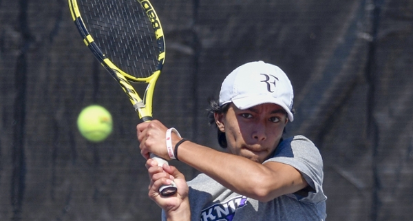 Knights men's tennis player on the court during a match. 